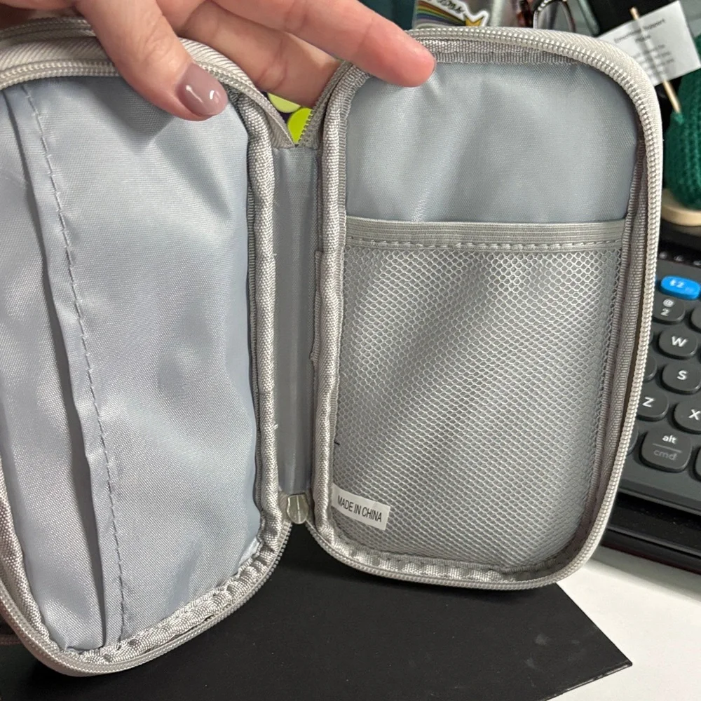 Silver Travel Bag for Charger, Plugs, and Earbuds.